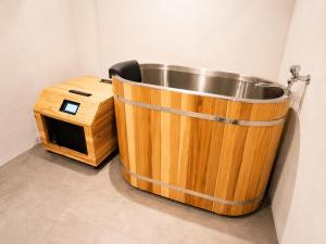 a wooden bath tub next to a dog house at KAJAhause in Osaka