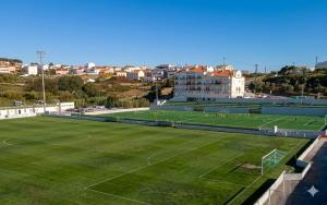 a soccer field with a soccer team on it at I Love U villa in Ericeira