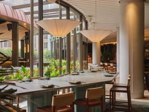 a large dining room with a long table and chairs at Sofitel Sydney Wentworth in Sydney +104 photos