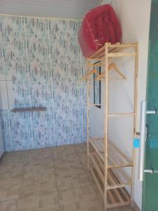 a room with a bunk bed and a ladder at Pousada Maia em Flor chale azul in Resende +1 photo