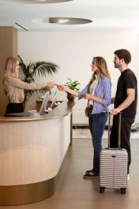 a group of people in an office shaking hands at Grand Duka Hotel & SPA in Durrës