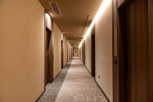a hallway with a long aisle with lights on it at Grand Duka Hotel & SPA in Durrës +96 photos