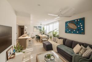 a living room with a couch and a table at Esprit Holidays Rainbow Bay in Gold Coast
