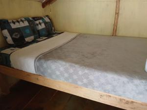 a bed in a small room with a mattress at Aldea Axocobaca in Zoquitlán