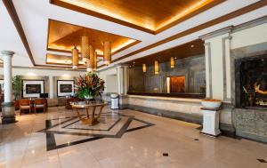 a lobby with a table and a fireplace at Kuta Seaview Beach Resort in Kuta +62 photos