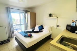 a hotel room with a bed and a sink at Townhouse Apartment Hotel Suva in Suva