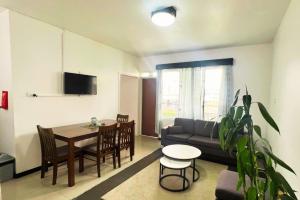 a living room with a couch and a table at Townhouse Apartment Hotel Suva in Suva