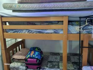 a bunk bed with a suitcase on the bottom bunk at Barrinha Beach flats in Saquarema