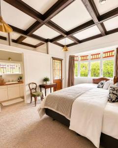 a bedroom with a large bed and a desk at 21 Villa in Whangarei