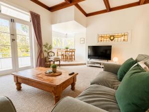 a living room with a couch and a coffee table at 21 Villa in Whangarei