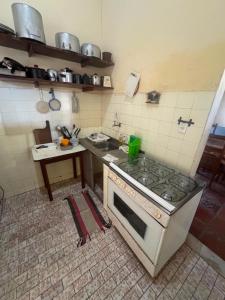 a kitchen with a stove and a counter top at Casa de Praia do Morro Branco in Beberibe