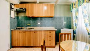 a small kitchen with wooden cabinets and a table at Hotel Nilahue in Viña del Mar