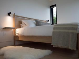 a bedroom with a bed with white sheets and a window at Ridge On The Chimney - 4 Cottages in Chimney Corner +43 photos