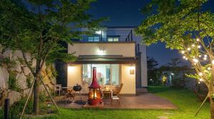 a house with a red lamp on a deck at night at Sokcho Biroso Private Cottage in Sokcho