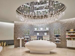 a room with a white table and a chandelier at Sofitel Dubai Downtown in Dubai
