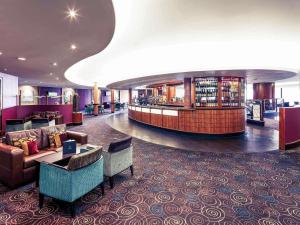 a hotel lobby with a waiting area and a library at Mercure Manchester Piccadilly Hotel in Manchester