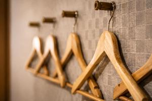 a group of wooden hangers hanging on a wall at kaguya asakusa Women only guest house in Tokyo