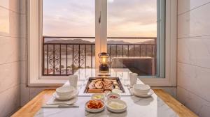 a table with a plate of food and a window at Gapyeong Ribbon Spa Pool Villa in Gapyeong