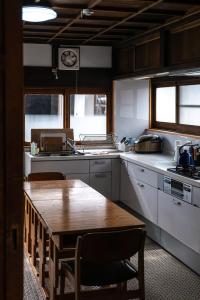 a kitchen with a wooden table and a counter top at tehen in Kyoto +31 photos