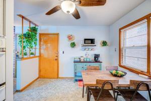 a dining room with a table and a ceiling fan at 90s Condo| King Bed | 65” Smart TV | Arcade Game in Elmwood Park