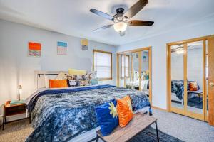 a bedroom with a bed and a ceiling fan at 90s Condo| King Bed | 65” Smart TV | Arcade Game in Elmwood Park