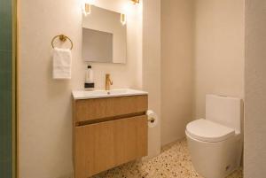 a small bathroom with a toilet and a sink at Room 4: Minimalist Bunk Room w/ Free Parking | San Juan in San Juan