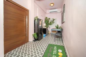 a hallway with a door and a table and a rug at Room 4: Minimalist Bunk Room w/ Free Parking | San Juan in San Juan +27 photos