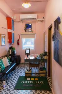 a room with a hotel lobby with a couch and a table at Room 4: Minimalist Bunk Room w/ Free Parking | San Juan in San Juan