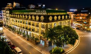 a large building on a city street at night at Canvas Sapa Legend Hotel in Sapa