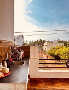a balcony with a sink and a view of a train at AURO BAY inn in Kuilapayam