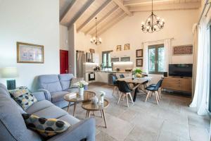 a living room with a couch and a table at Villa Ares in Bogdanátika