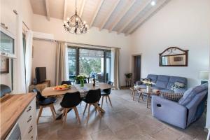 a living room with a blue couch and a table at Villa Ares in Bogdanátika