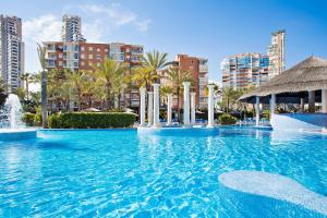 a large swimming pool with a fountain in a city at SOL by Meliá Pelícanos Ocas in Benidorm +40 photos