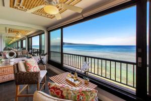 a room with a balcony with a view of the ocean at Maui Kai 405 in Honokowai +34 photos