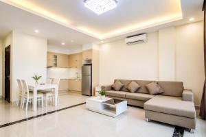 a living room with a couch and a table at Phnom Penh Star Apartment in Phnom Penh