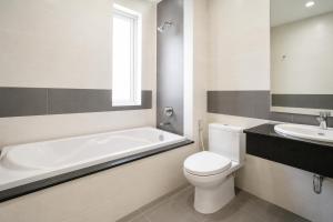 a bathroom with a tub and a toilet and a sink at Phnom Penh Star Apartment in Phnom Penh +13 photos