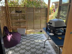 a grill sitting on a table in a patio at Mapua Cabbage Trees in Mapua