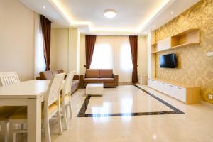 a room with a dining table and a living room at Phnom Penh Star Apartment in Phnom Penh