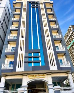 a tall building with a blue facade at Phnom Penh Star Apartment in Phnom Penh