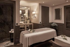 a massage room with a bed and a sink at MiM Ibiza member of Meliá Collection in Ibiza Town