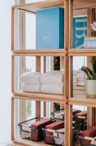 a shelf filled with towels and other items at MiM Ibiza member of Meliá Collection in Ibiza Town