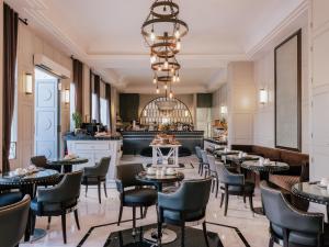 a restaurant with tables and chairs and a bar at MiM Ibiza member of Meliá Collection in Ibiza Town +39 photos