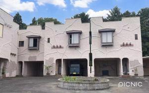 a large building with a courtyard in front of it at ホテルＪoＪo in Ikaho +9 photos