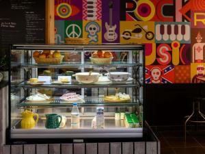 a display case with food items on display at Greet Hotel Evreux Centre - Route de Normandie by Accor in Évreux