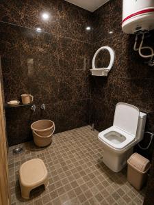 a bathroom with a toilet and a sink at Derban guest house in Srinagar