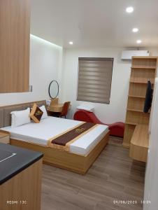 a bedroom with a bed and a staircase in it at Nam Thanh Hotel in Nhật Tựu