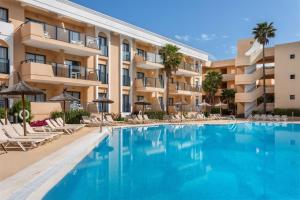 an image of a swimming pool in front of a building at SOL by Meliá Sancti Petri in Chiclana de la Frontera