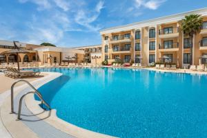 a large swimming pool in front of a hotel at SOL by Meliá Sancti Petri in Chiclana de la Frontera