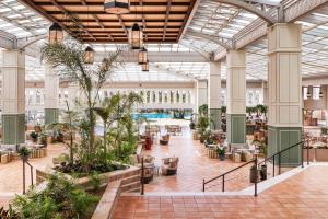a view of the lobby of a shopping mall with plants at Meliá Isla Canela in Isla Canela