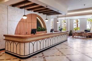 a lobby with a reception desk in a building at Meliá Isla Canela in Isla Canela